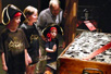 Image: A family looks at a treasure chest in the exhibit.